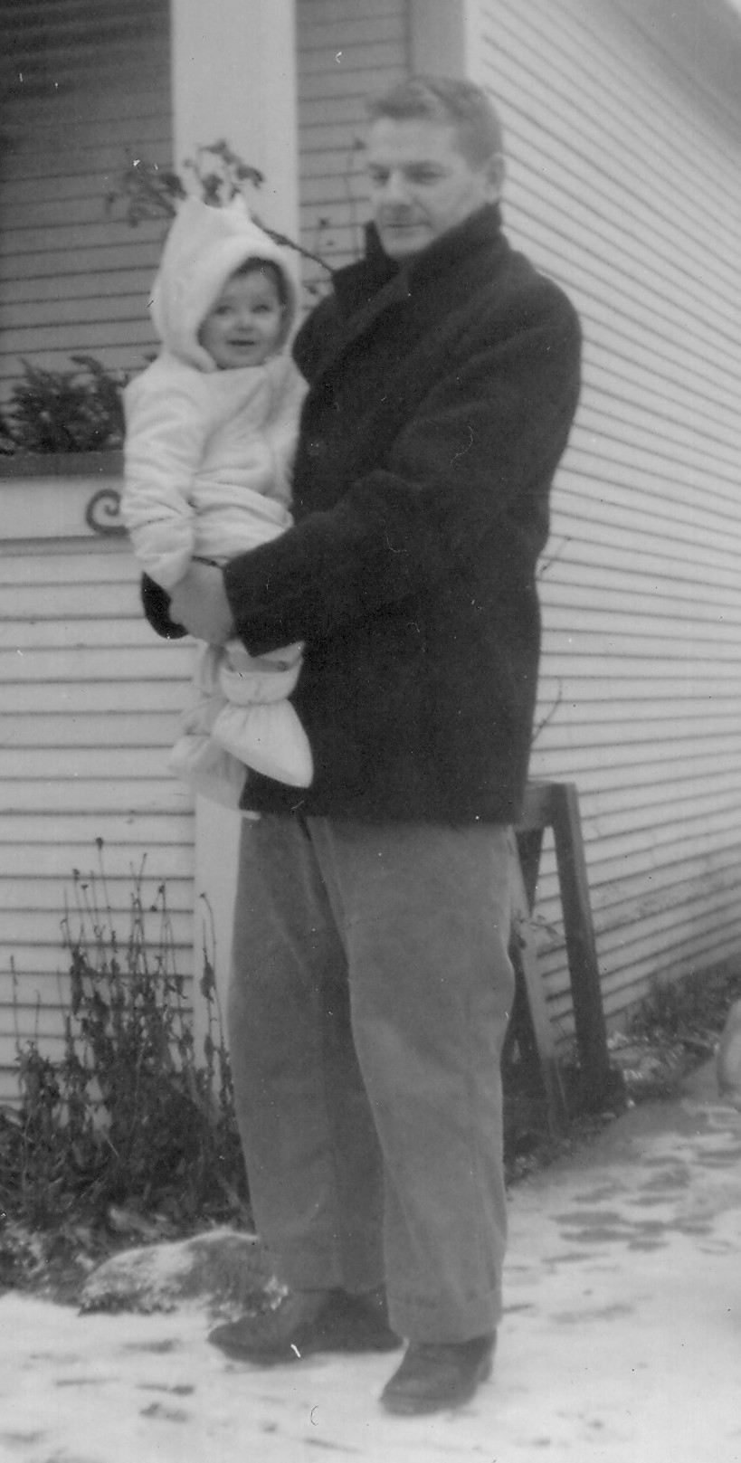 Ernie Frazer holding daughter Karen, in the driveway of their Audley St home in Victoria, BC